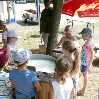 Konzentriert schöpfen die Kinder beim Ferienspaß „Papierwerkstatt“ in Euerbach aus Holzbütten den Faserbrei für die Papierfertigung.